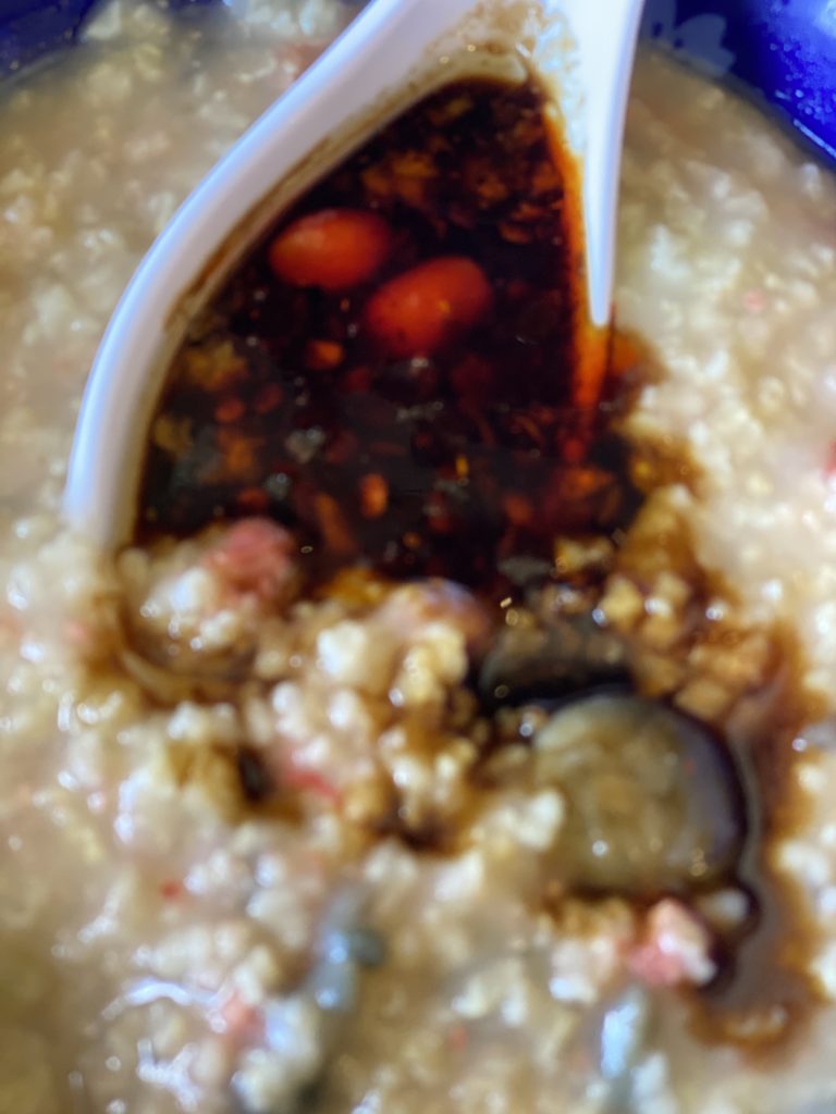 Millet jook with preserved duck egg and a spoonful of Lao Gan Ma