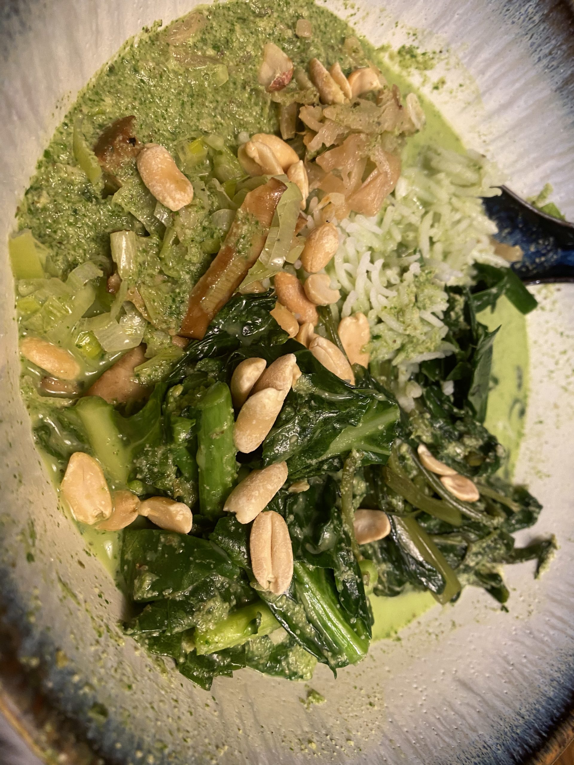 A bowl of liu cha fan: rice, vegetables, a green tea soup, and peanuts on the top